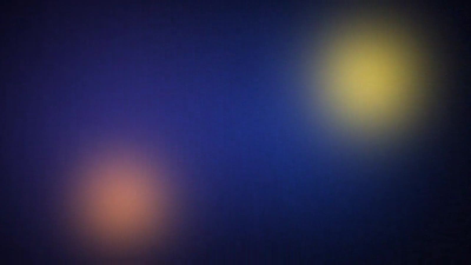 Abstract glow of gold and amber light on navy