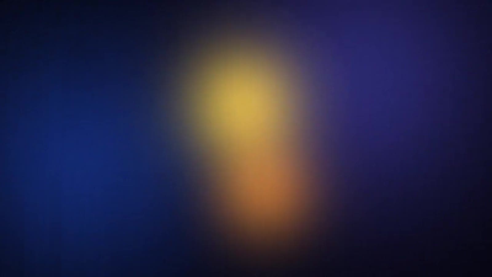 Abstract glow of amber and gold light on navy